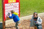 Student using a communication board on the playground